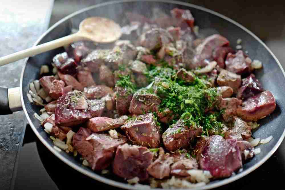 Cooking beef heart in a pan