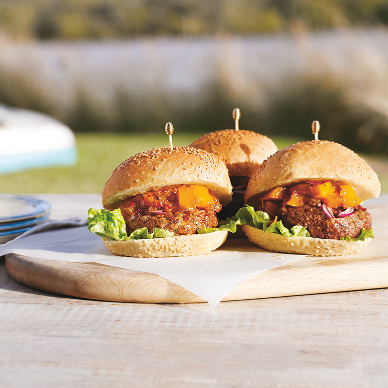 barbecued beef burgers flavoured with red onion and chopped basil topped with sticky mango and chilli relish