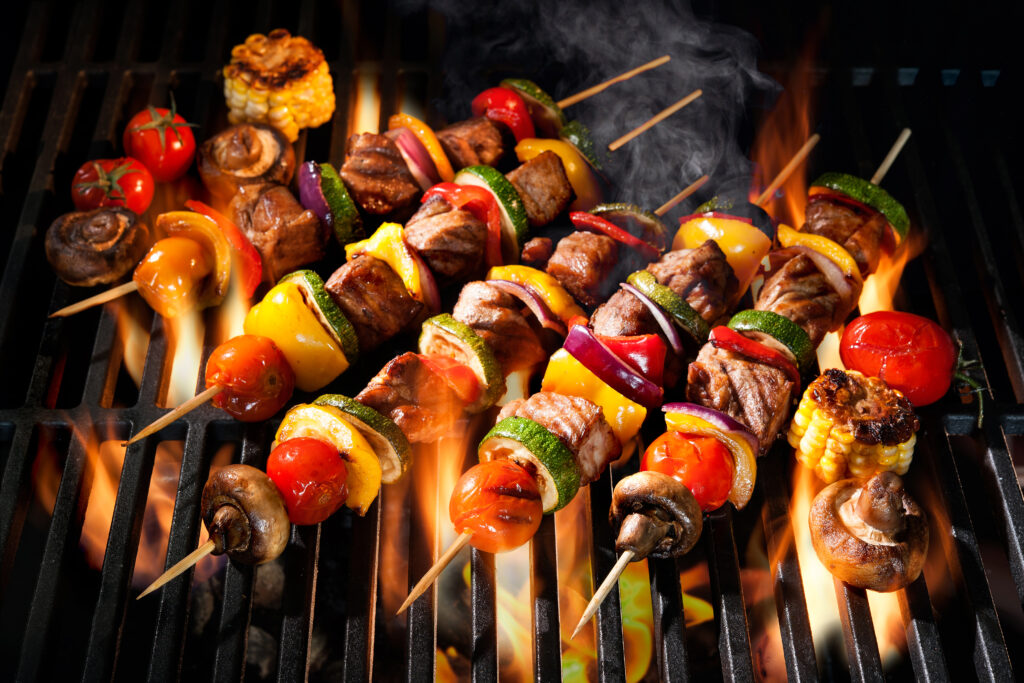 barbecue,skewers,meat,kebabs,with,vegetables,on,flaming,grill